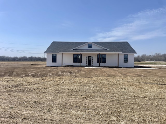 modern inspired farmhouse with covered porch and a shingled roof