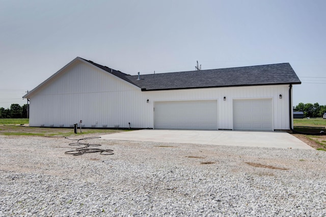 1883 S Farm Rd Unit 107, Springfield, MO 65802 - view of property exterior featuring concrete driveway, roof with shingles, and an attached garage