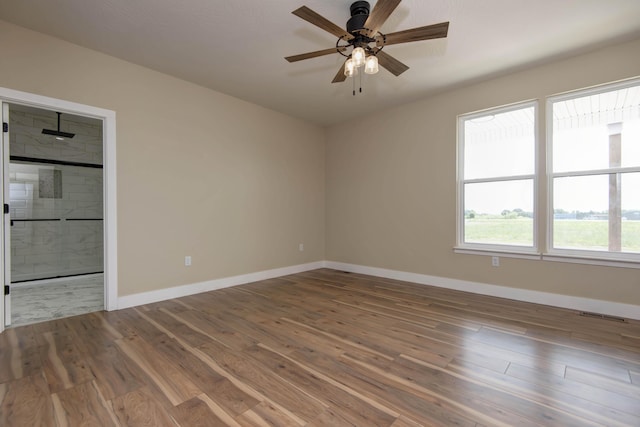 1883 S Farm Rd Unit 107, Springfield, MO 65802 - empty room featuring baseboards, ceiling fan, and wood finished floors
