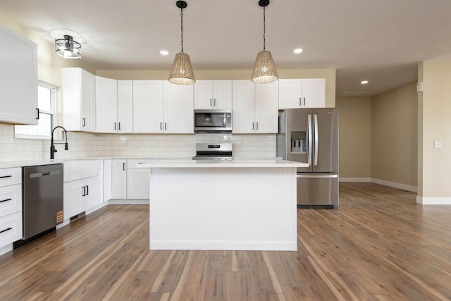 1883 S Farm Rd Unit 107, Springfield, MO 65802 - kitchen with stainless steel appliances, light countertops, backsplash, baseboards, and recessed lighting