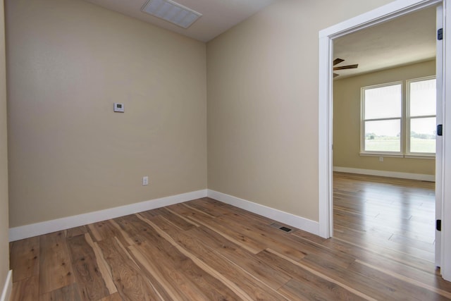 1883 S Farm Rd Unit 107, Springfield, MO 65802 - unfurnished room with wood finished floors and baseboards