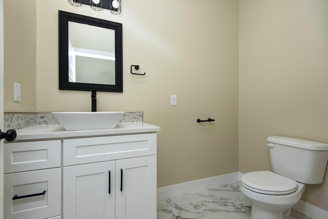 1883 S Farm Rd Unit 107, Springfield, MO 65802 - half bathroom with baseboards, toilet, marble finish floors, and vanity