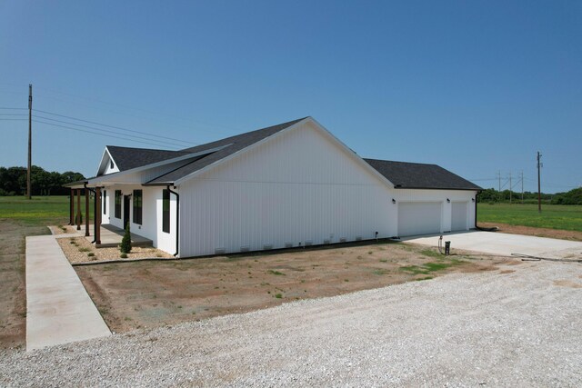 1883 S Farm Rd Unit 107, Springfield, MO 65802 - view of home's exterior with an attached garage, concrete driveway, and a shingled roof