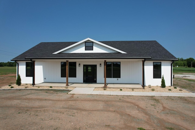 1883 S Farm Rd Unit 107, Springfield, MO 65802 - modern farmhouse style home featuring a porch and a shingled roof