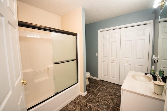 full bath featuring vanity, baseboards, a textured ceiling, toilet, and marble finish floor