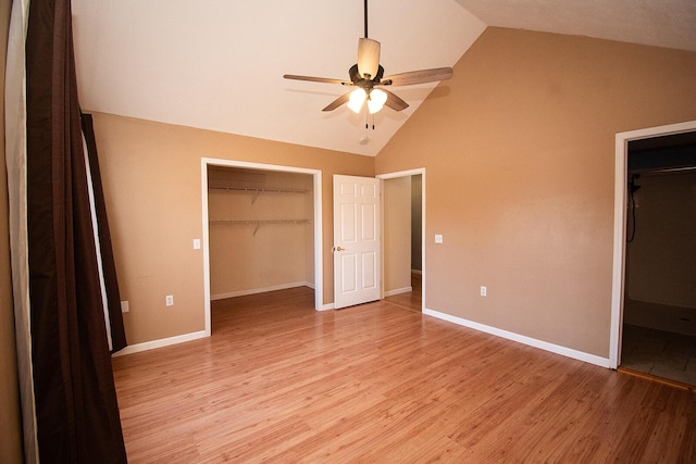 unfurnished bedroom with a spacious closet, baseboards, light wood-style floors, and a closet