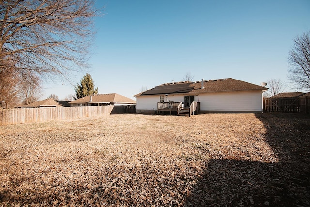 back of house featuring a fenced backyard