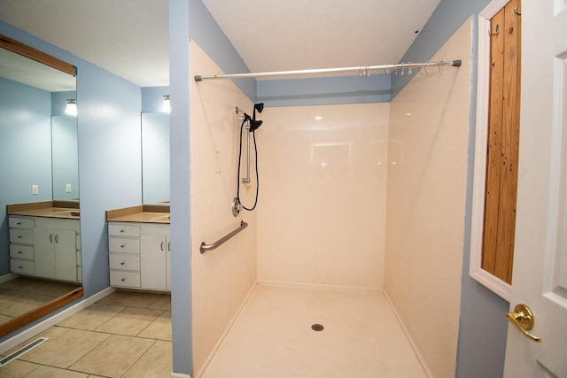 full bath featuring vanity, tile patterned floors, a shower, and visible vents