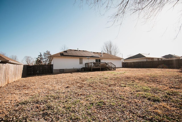 view of yard featuring a fenced backyard and a deck