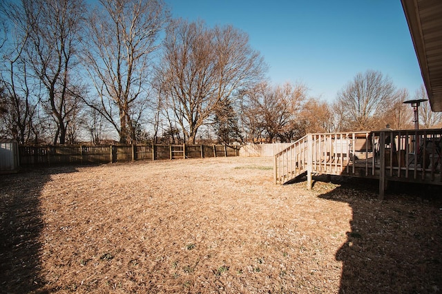 view of yard featuring a wooden deck and a fenced backyard