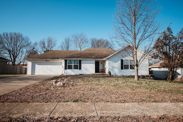 single story home featuring an attached garage, concrete driveway, and fence