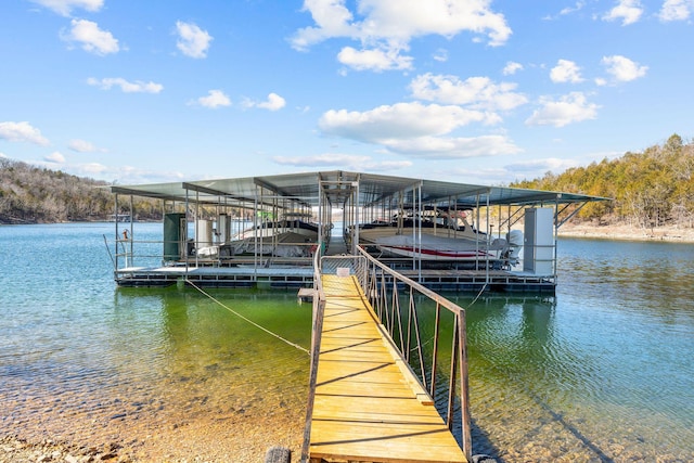 dock area with a water view and boat lift
