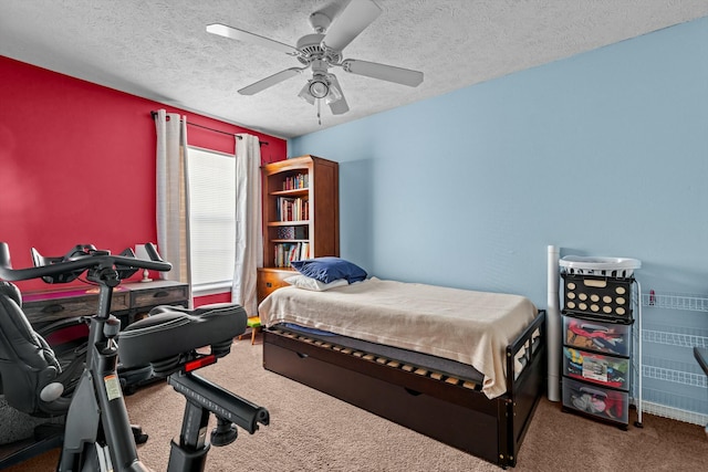 carpeted bedroom with a textured ceiling and a ceiling fan