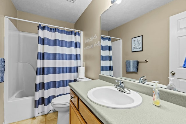 bathroom featuring tile patterned flooring, toilet, vanity, shower / tub combo, and a textured ceiling