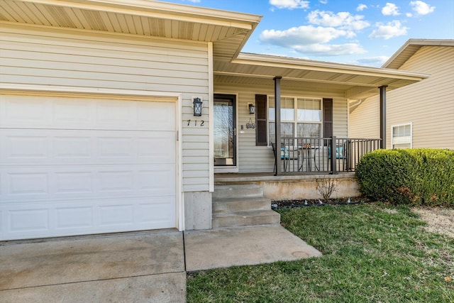 property entrance with a porch, concrete driveway, and an attached garage