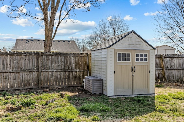 view of shed with a fenced backyard