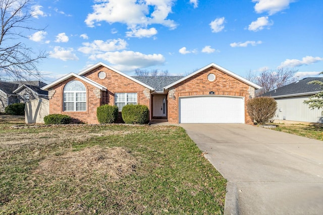 ranch-style home featuring concrete driveway, an attached garage, brick siding, and a front lawn