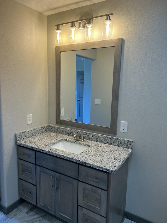 bathroom with vanity and baseboards