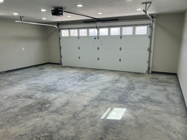 garage with recessed lighting, baseboards, and a garage door opener