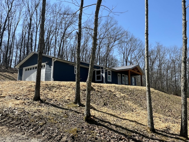 view of side of home featuring a garage