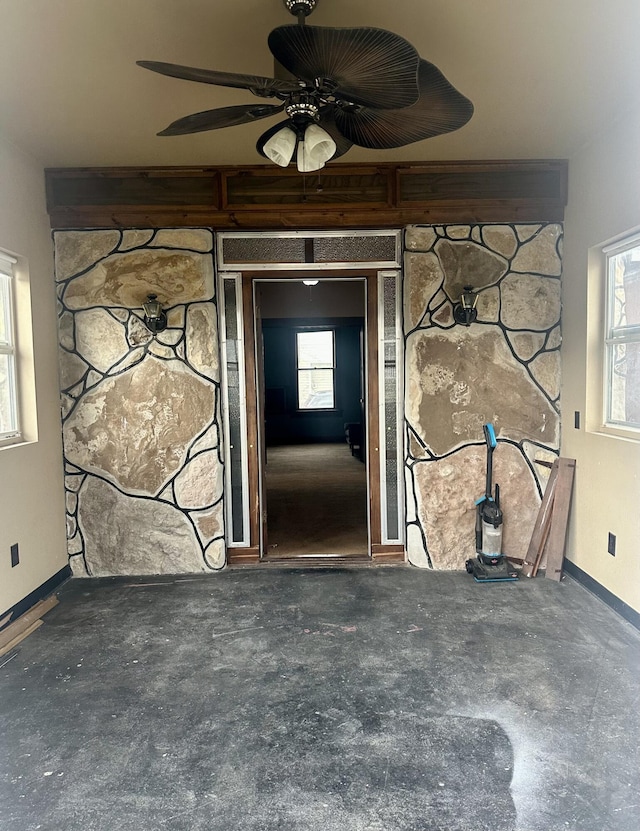 view of exterior entry featuring ceiling fan