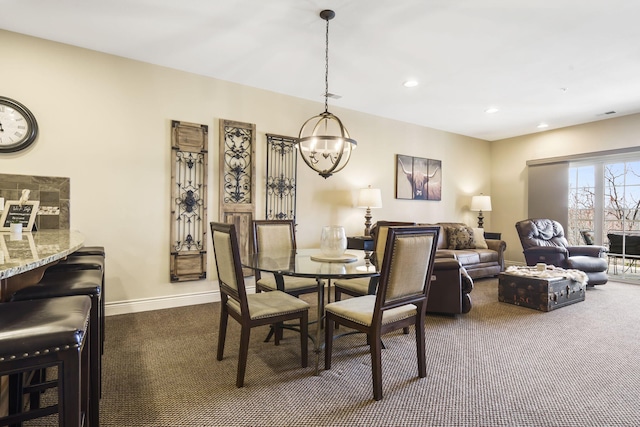 dining room featuring recessed lighting, baseboards, dark colored carpet, and a chandelier