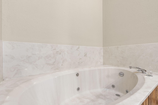 full bathroom with a whirlpool tub