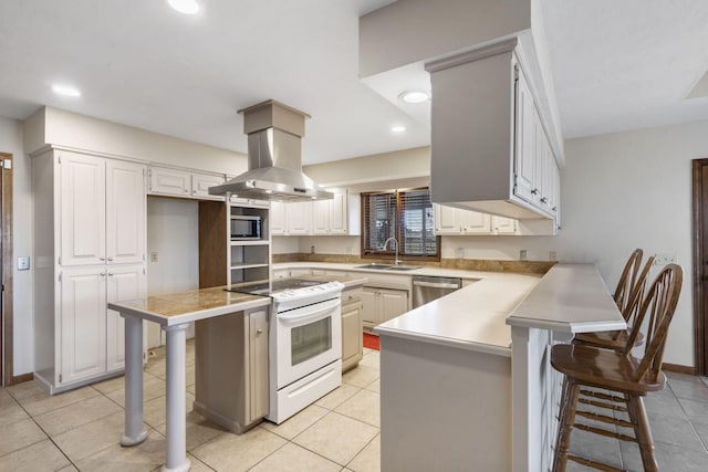 kitchen featuring a breakfast bar, a sink, appliances with stainless steel finishes, and island range hood