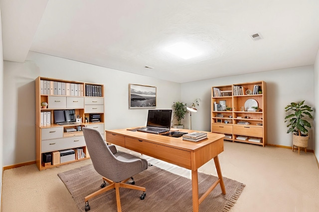 office with visible vents, light carpet, and baseboards