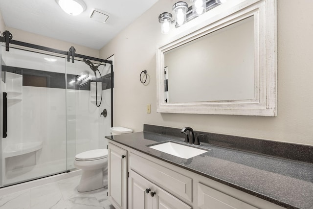 bathroom with vanity, a shower stall, toilet, and marble finish floor