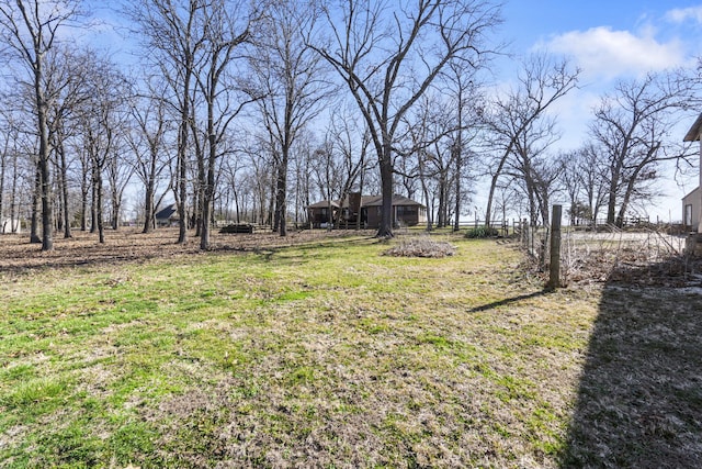 view of yard with an outbuilding and fence