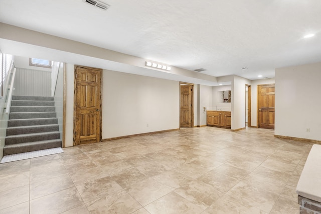 unfurnished living room featuring stairs, recessed lighting, baseboards, and visible vents