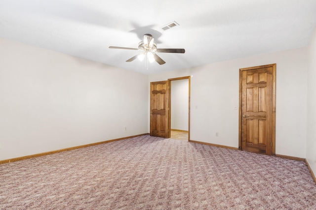 empty room with a ceiling fan, baseboards, visible vents, and carpet floors