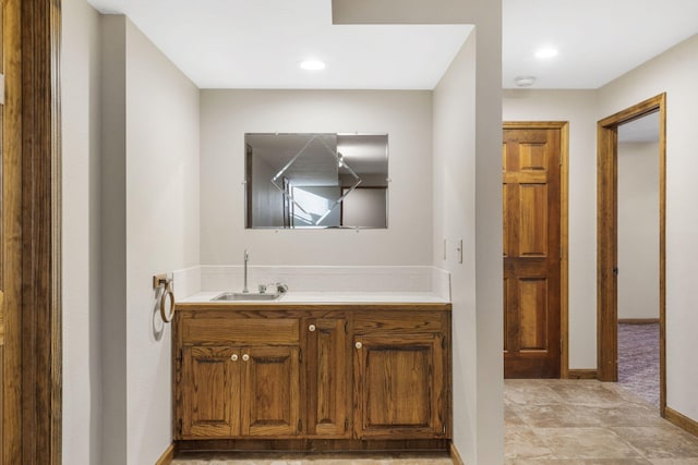 bathroom with a sink and baseboards