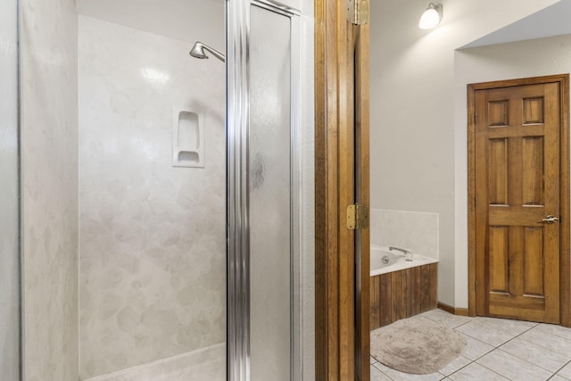 full bathroom with tile patterned floors, a stall shower, and a bath