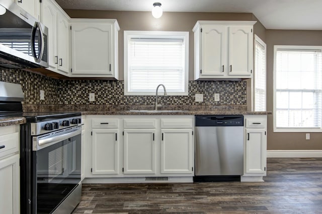 kitchen featuring a sink, plenty of natural light, appliances with stainless steel finishes, and white cabinets