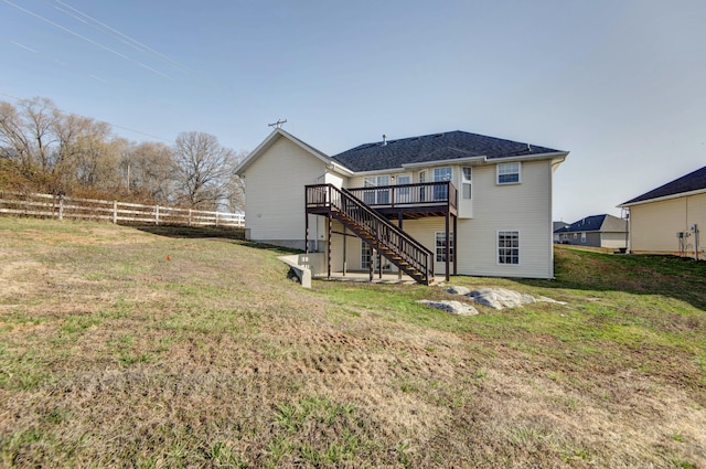 rear view of house featuring a yard, a deck, stairs, and fence