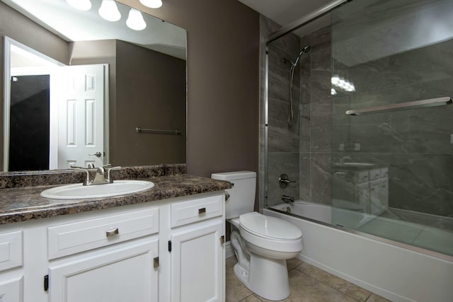 full bathroom featuring tile patterned floors, toilet, vanity, and enclosed tub / shower combo