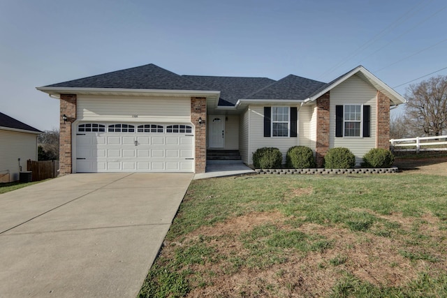 ranch-style house with brick siding, an attached garage, a front yard, and fence