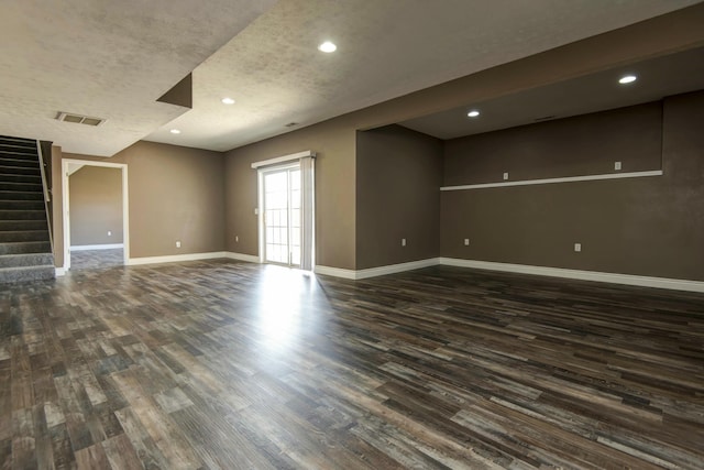 unfurnished living room with visible vents, baseboards, stairway, recessed lighting, and dark wood-style flooring