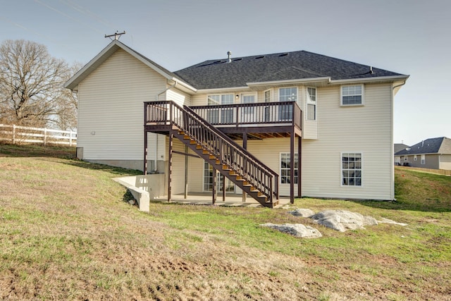 rear view of property with a deck, a patio, fence, stairway, and a yard