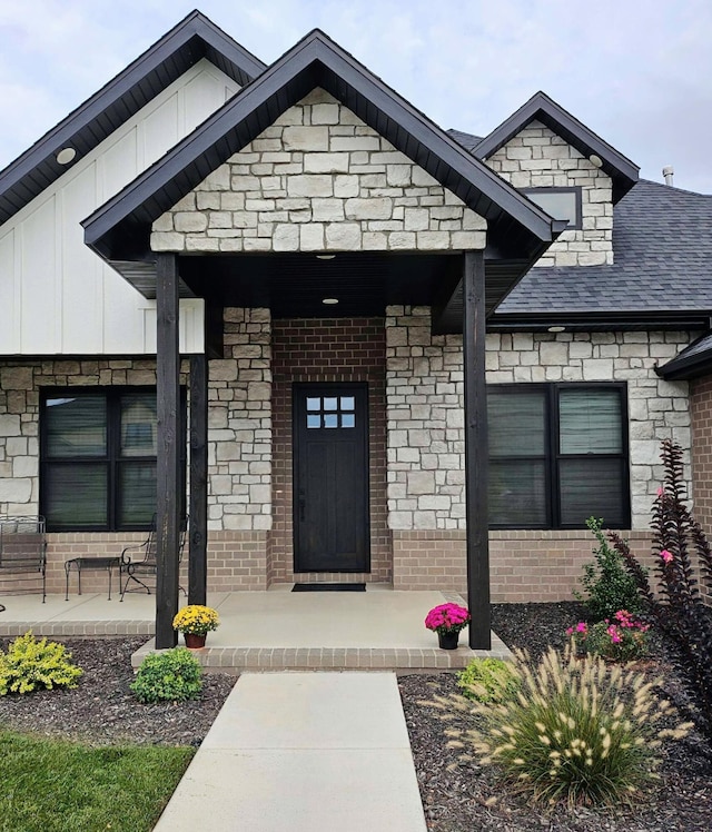 entrance to property featuring covered porch and board and batten siding