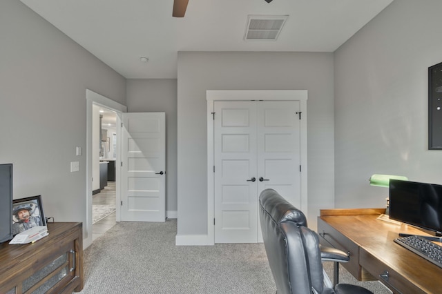 office featuring visible vents, baseboards, a ceiling fan, and carpet floors