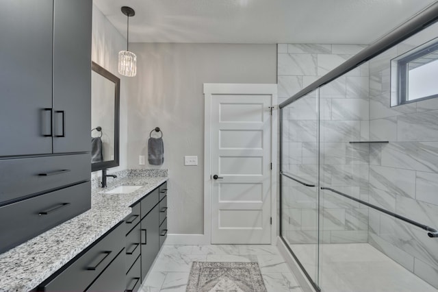 full bathroom featuring vanity, baseboards, marble finish floor, and a stall shower