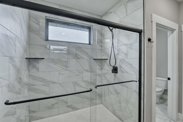 full bathroom with toilet, a stall shower, and marble finish floor