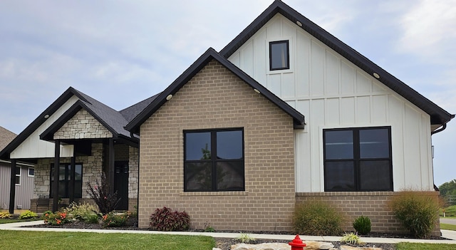 modern farmhouse with brick siding and board and batten siding