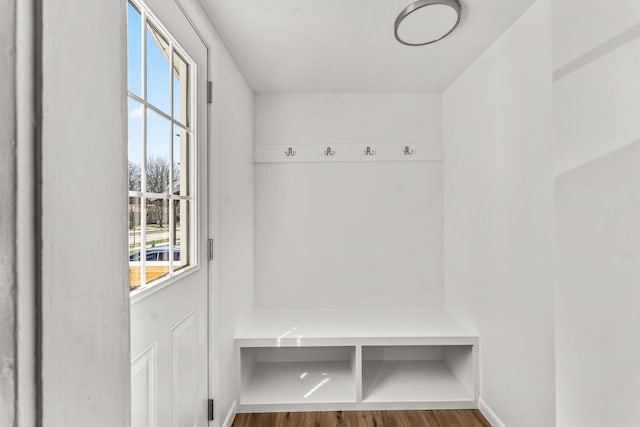 mudroom with wood finished floors and baseboards