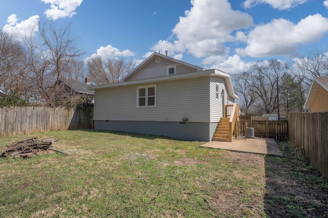 back of house with a patio area, a lawn, and a fenced backyard