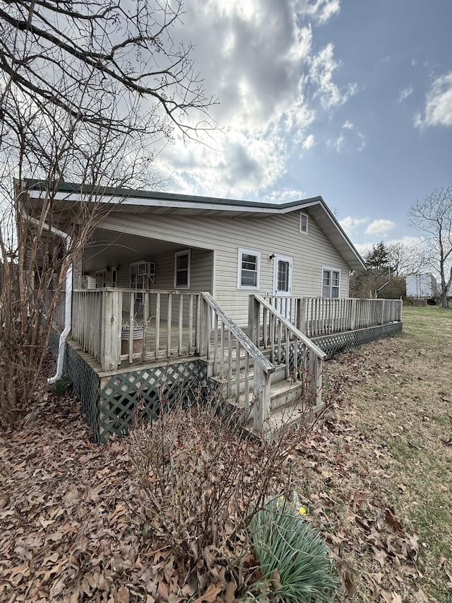 back of house featuring a wooden deck