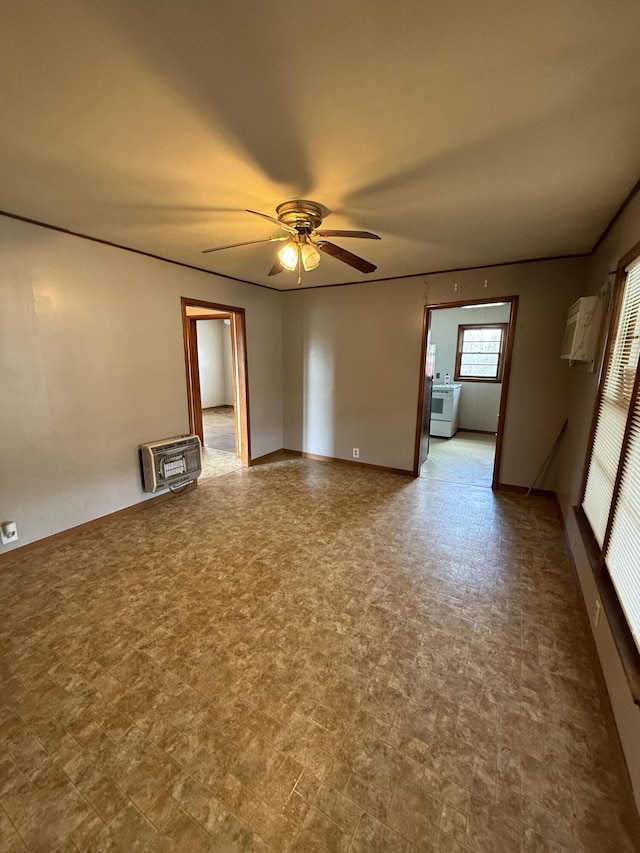 spare room with heating unit and ceiling fan